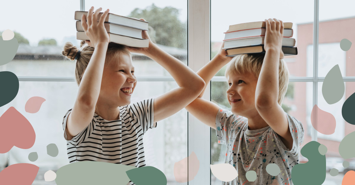 featured image showing two laughing children holding books over their heads